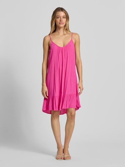 Frauenmodel trägt Minikleid aus Viskose mit tiefem Rückenausschnitt von Shiwi in A-Linie, kräftiges Pink, strukturierte Oberfläche, verstellbare Träger, Ganzkörperansicht von vorne. Modell 'Ibiza Dress Solid', Rückenlänge 68 cm, Brustweite 35 cm.