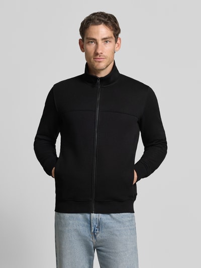 Männermodel trägt Regular Fit Sweatjacke aus Baumwoll-Mix von s.Oliver RED LABEL in Schwarz, glatte Struktur, Ganzkörperansicht von vorne.
