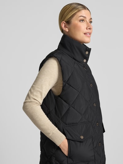 Vrouwenmodel draagt zwarte bodywarmer in stiksels, regular fit, opstaande kraag, opgestikte zakken, FREE/QUENT, Model 'Olga', Nahaufnahme Oberkörper