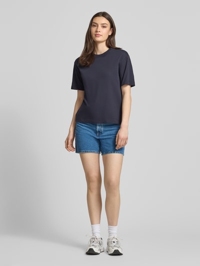 Frauenmodel trägt Bermuda Leg Jeansshorts aus reiner Baumwolle von Marc O'Polo Denim in klassischem Denim-Blau, 5-Pocket-Design, Ganzkörperansicht von vorne.