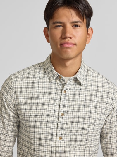Männermodel trägt Slim Fit Freizeithemd aus reiner Baumwolle Modell 'GUDMUND' von ONLY, kariertes Muster in Beige und Schwarz, Nahaufnahme Oberkörper, Herren Freizeithemd von ONLY & SONS.