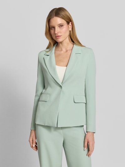 Vrouwenmodel draagt blazer met klepzakken model 'Isa' van GUIDO MARIA KRETSCHMER WOMAN in mintgroene materiaalmix met stretch, recht model, reverskraag, knoopsluiting, detailopname bovenlichaam.