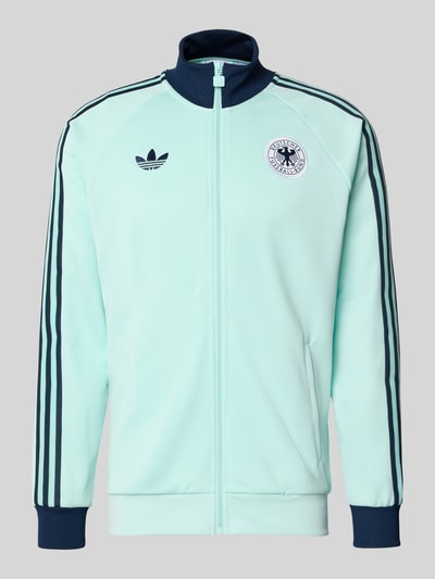 Produktfoto, Regular Fit Trainingsjacke mit Baumwoll-Anteil und DFB-Logo von adidas Originals, Optik: Unifarben in Mint mit Kontraststreifen, Reißverschluss, Label-Stitching, Stehkragen, Langarm, seitliche Eingrifftaschen, glatte Textur.