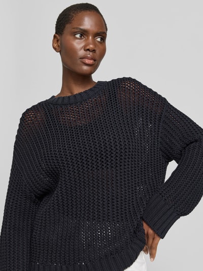 Frauenmodel trägt Pullover in Strick-Optik von Juvia aus Baumwoll-Mix, relaxed-fit, semitransparent, Rundhalsausschnitt, Nahaufnahme Oberkörper.