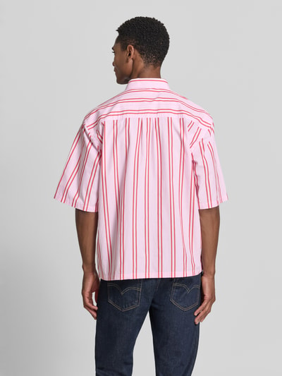 Männermodel trägt Regular Fit Freizeithemd mit Kentkragen und Brusttasche von Lindbergh, rot-weiß gestreift aus reiner Baumwolle, Ganzkörperansicht Rückansicht, allover Look, Label-Stitching, bei Größe M Rückenlänge 68 cm, Schulterbreite 47 cm, Ärmellänge 31 cm.