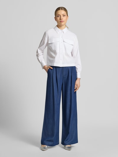 Frauenmodel trägt Wide-Leg-Pants mit Eingrifftaschen von Liu Jo White aus Lyocell in Blau, ausgestellter Schnitt, Knopf-Reißverschluss, Ganzkörperansicht von vorne.