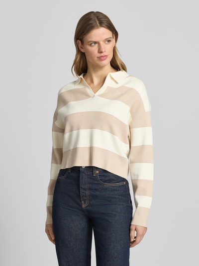Frauenmodel trägt Strickpullover mit Polokragen von Guess Jeans im Viskose-Mix, Lockerer-Schnitt, beige-weiße Streifen, Ganzkörperansicht von vorne.