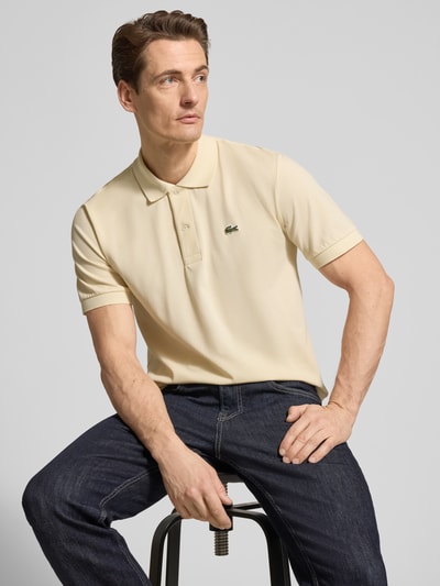 Männermodel trägt Regular Fit Poloshirt aus Baumwoll-Mix von Lacoste, Optik: Unifarben, Logo-Detail, Polokragen, Piqué, Nahaufnahme Oberkörper.