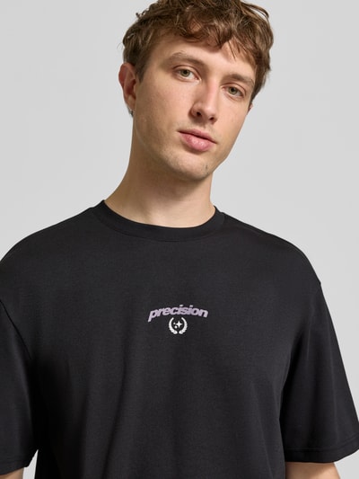Männermodel trägt Regular Fit T-Shirt aus Baumwoll-Mix Modell 'CASPIAN' von Only & Sons, Optik: Unifarben, Schriftzug-Applikation, Nahaufnahme Oberkörper.