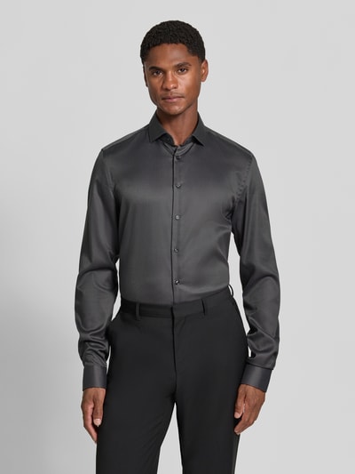 Männermodel trägt Slim Fit Businesshemd in Premiumqualität mit extra langem Arm von Jake*s, dunkles Big Twill-Baumwollgewebe, Ganzkörperansicht von vorne.