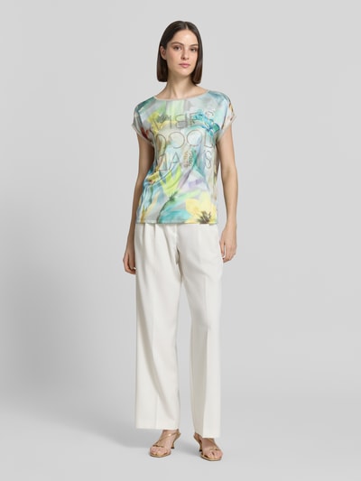 Frauenmodel trägt T-Shirt aus Viskose-Mix mit Strasssteinbesatz von Betty Barclay, Pastellfarben, Rundhalsausschnitt, Straight Fit, Ganzkörperansicht von vorne, Rückenlänge bei Größe 36: 61 cm, Stretch-Anteil, Kontrastkante.