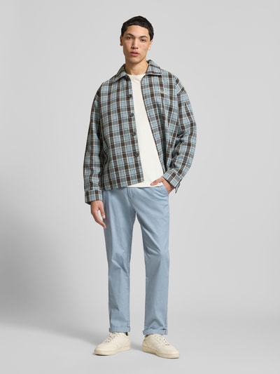 Mannelijk model draagt lichtblauwe straight fit stoffen broek uit mix van katoen en elastaan, model 'MARCO FURY' van Jack & Jones, met steekzakken, knoop- en ritssluiting, bandwijdte 44 cm, binnenbeenlengte 77 cm, ganzkörperaanzicht van voren.