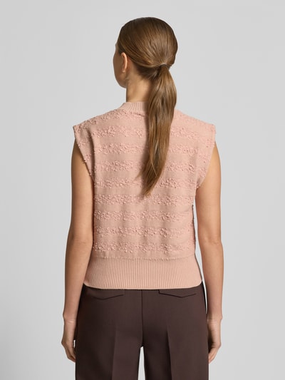 Frauenmodel trägt Strickweste mit Rundhalsausschnitt von Scotch & Soda aus Baumwoll-Mix, Slim-Fit, Rückenlänge 51 cm, Ganzkörperansicht Rückansicht.