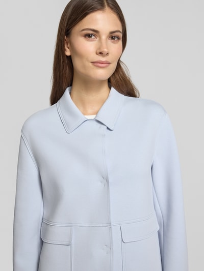 Frauenmodel trägt Blazer mit Kentkragen und aufgesetzten Pattentaschen von WHITE LABEL im hellblauen Farbton, Baumwoll-Mix mit Stretch-Anteil, gerader Schnitt, verdeckter Verschluss, strukturierte glatte Oberfläche, Nahaufnahme Oberkörper. Rückenlänge bei Größe 36: 57 cm, Brustweite: 51 cm, Ärmellänge: 61 cm.