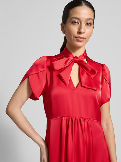 Kobiece modelka nosi sukienka midi z dekoltem w serek i kokardą od Christian Berg Woman Selection, satyna, linia a, rękawy-motylki, wszyty zamek błyskawiczny z boku, długość tyłu w rozmiarze 36: 111 cm, szerokość w rozmiarze 36: 46 cm, detaliczne zdjęcie górnej części ciała