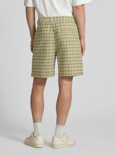 Männermodel trägt Shorts mit Strukturmuster Modell 'Kander' von Carhartt Work In Progress, Regular Fit, Rückansicht, Nahaufnahme Oberschenkel.