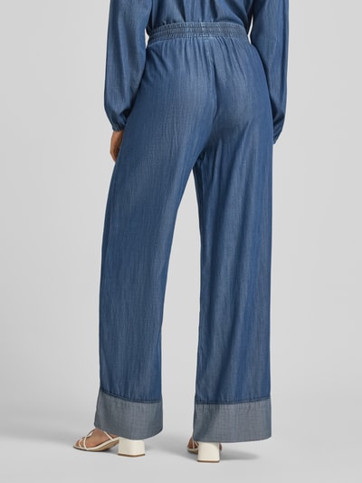 Frauenmodel trägt Loose Fit Jeans mit Viskose-Anteil Modell 'Wilke' von FREE/QUENT in Blau, elastischer Bund, fixierte Beinabschlüsse, Ganzkörperansicht Rückansicht.