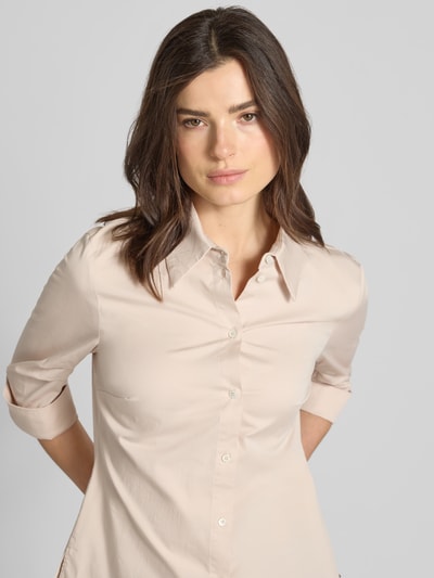 Frauenmodel trägt Hemdbluse mit 3/4-Arm mit Aufschlag von Marc Cain aus Baumwoll-Viskose-Mix in Beige, Nahaufnahme Oberkörper.
