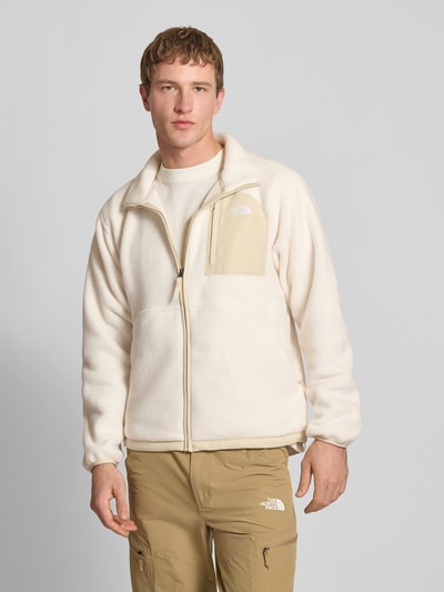 Männermodel trägt Fleecejacke mit Napoleontasche Modell 'YUMIORI' von The North Face, Beige- und Cremetöne, gerade Passform, Nahaufnahme Oberkörper, Herren Fleecejacke, durchgehender Reißverschluss, Eingriffstaschen, elastische Abschlüsse