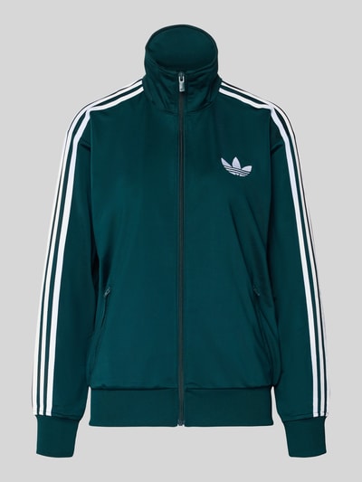 Produktfoto, bluza rozpinana z stójką od adidas Originals, luźny krój, wyhaftowane logo, kieszenie zapinane na zamek błyskawiczny, prążkowane wykończenia, ciemnozielona z białymi detalami.