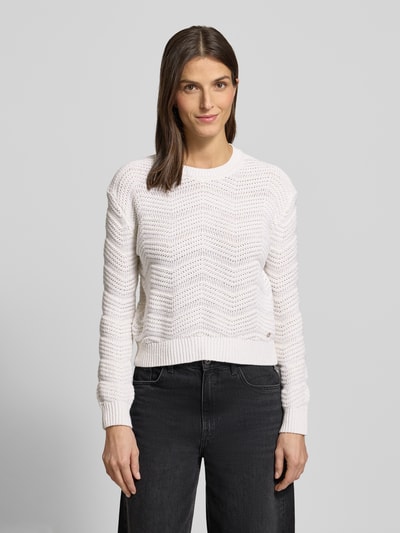 Frauenmodel trägt Strickpullover mit gerippten Abschlüssen von Guess in Offwhite, lockerer Schnitt, Baumwoll-Mix, Ganzkörperansicht von vorne.
