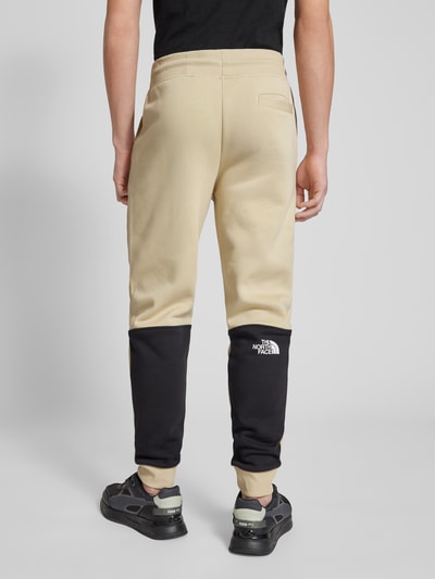 The North Face Spodnie dresowe o kroju regular fit z nadrukiem z logo model ‘ICONS’ Beżowy 5