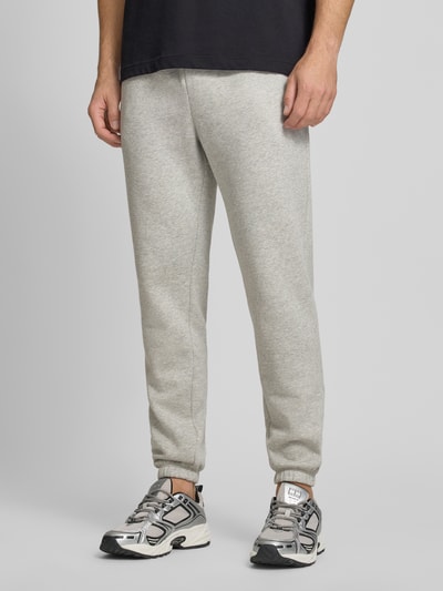 Männermodel trägt Sweatpants mit Logo und elastischem Bund von GAP, grau, Baumwoll-Mix, Regular-Fit, Logo, Ganzkörperansicht von vorne.