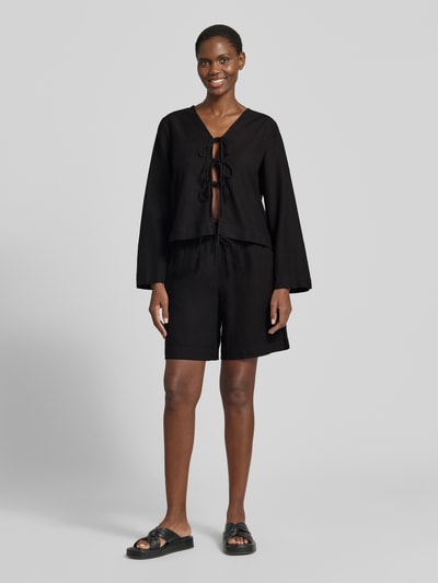 Frauenmodel trägt Leinenshorts mit elastischem Bund Modell 'Lava' von FREE/QUENT in Schwarz, Leinen-Mix mit Viskose, Loose Fit, Ganzkörperansicht von vorne.