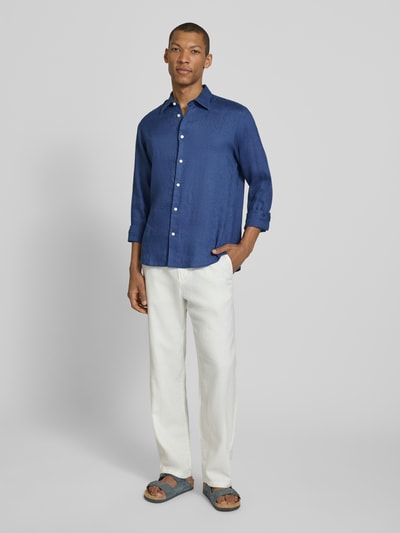 Männermodel trägt Regular Fit Freizeithemd aus reinem Leinen Modell 'REGKYLIAN' von SELECTED HOMME, unifarbenes Blau, Ganzkörperansicht von vorne.