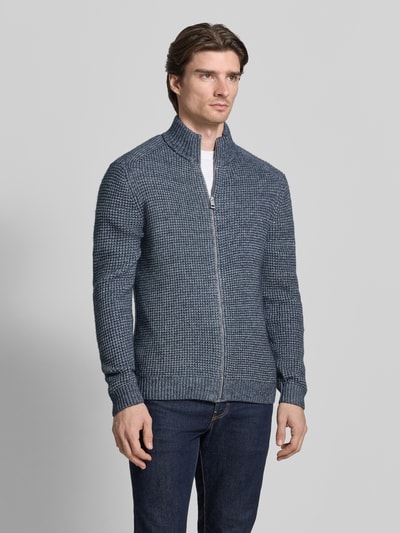 Männermodel trägt Regular Fit Strickjacke mit Woll-Anteil von Tom Tailor in Melange-Optik, Reißverschluss, Stehkragen, Ganzkörperansicht von vorne.
