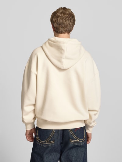 Männermodel trägt Oversized Hoodie aus Baumwoll-Mix Modell 'LEROY' von Only & Sons in Creme, unifarben, Ganzkörperansicht Rückansicht.