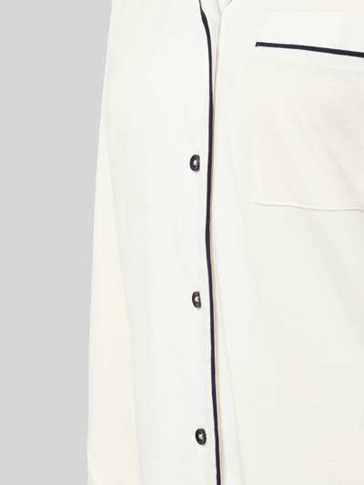 Frauenmodel trägt Regular Fit Pyjama-Oberteil mit Brusttasche von Christian Berg Woman aus Baumwoll-Modal-Mix, Knopfleiste, Detailaufnahme.