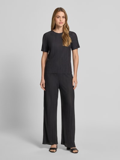 Frauenmodel trägt schwarze Wide Leg Hose mit Plisseefalten Modell 'PLISA' von Vila aus Material-Mix mit Viskose-Anteil, Ganzkörperansicht von vorne.