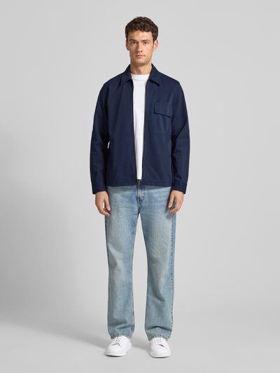 Männermodel trägt Regular Fit Hemdjacke aus reiner Baumwolle Modell 'M_LORUM' von BOSS Orange in Unifarben mit Umlegekragen, Logo-Applikation, Langarm und Brusttasche, Ganzkörperansicht von vorne.