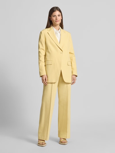 Vrouwenmodel draagt Relaxed Fit Blazer met Pattentaschen van Scotch & Soda, mix van katoen en lyocell, lichtgeel, klepzakken, reverskraag, knoopsluiting, relaxed fit, maat S, ruglengte 74 cm, borstwijdte 42 cm, mouwlengte 62 cm, volledig lichaam van voren.