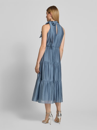 Frauenmodel trägt Cocktailkleid aus Viskose-Mix im Stufen-Look von Christian Berg Cocktail in Blau mit Schleifen-Applikation, A-Linie, Midikleid, Stehkragen, Rückenlänge 129 cm, Brustweite 46 cm, Ganzkörperansicht Rückansicht.