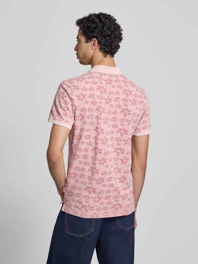 Männermodel trägt Slim Fit Poloshirt mit kurzer Knopfleiste Modell 'FRISCO' von Blend in Rosa mit floralem Muster, reine Baumwolle, Rückansicht Ganzkörperansicht.