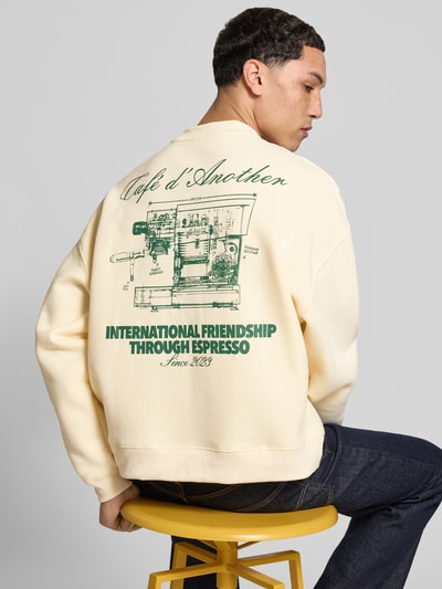 Männermodel trägt Regular Fit Sweatshirt mit Logo-Print von ANOTHER COTTON LAB in Creme mit grünem Print, Baumwoll-Mix, Ganzkörperansicht Rückansicht.