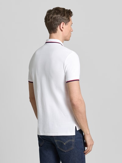 Männermodel trägt Slim Fit Poloshirt aus reiner Baumwolle von Polo Ralph Lauren, Optik: Unifarben, Kontraststreifen, Ganzkörperansicht Rückansicht.