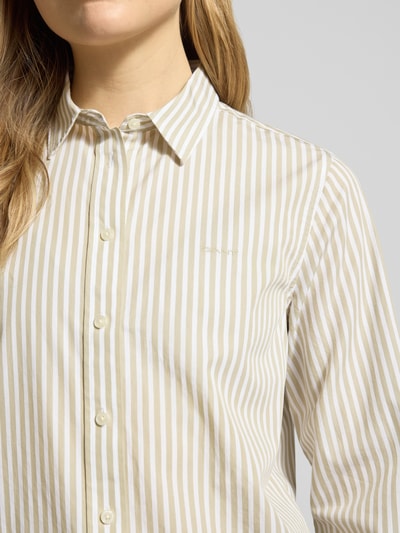 Frauenmodel trägt Regular Fit Bluse mit Streifenmuster und Label-Stitching von Gant aus reiner Baumwolle, Nahaufnahme Oberkörper.
