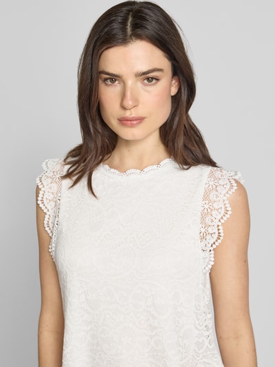 Kobiece model prezentuje Blusenshirt aus Häkelspitze od Apricot, mieszanka materiałów z dodatkiem streczu, prosty krój, okrągły dekolt, rękawy-motylki, długość tyłu w rozmiarze S: 16 cm, biała koronka, faktura szydełkowa, Nahaufnahme górnej części ciała.