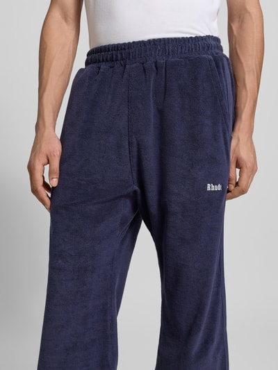 Männermodel trägt Sweatpants aus reiner Baumwolle von RHUDE in Dunkelblau, Frottee-Struktur, lockere Passform, Nahaufnahme Oberkörper.
