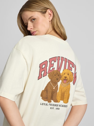 Frauenmodel trägt T-Shirt mit 1/2-Arm von REVIEW in Creme mit Hundeprint, Reine Baumwolle, Lockerer-Schnitt, Rundhalsausschnitt, Rückenlänge 68 cm, Ganzkörperansicht Rückansicht.
