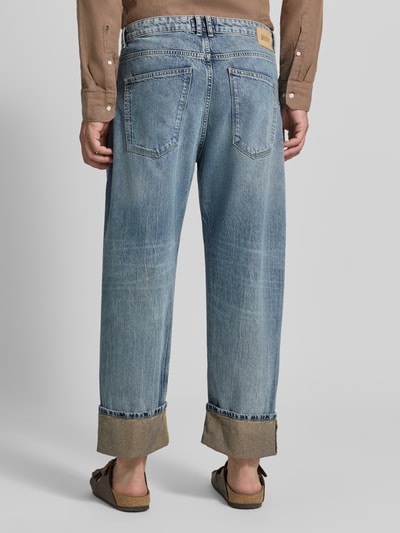 Męskimodel nosi jeansy model 'RAWDY' od DRYKORN z czystej bawełny, krój relaxed fit, efekt znoszenia, brzeg, Długość wewnętrzna nogawki 68 cm, Szerokość w rozmiarze 32/32: 46 cm, widok całej sylwetki z tyłu.