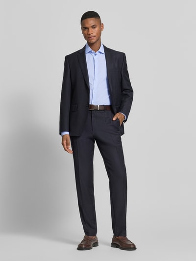 Männermodel trägt Slim Fit Businesshemd aus Baumwoll-Mix von Tommy Hilfiger, wzór w paski, krój slim fit, kołnierzyk typu kent, listwa guzikowa na całej długości, wyhaftowane logo, długi rękaw, mankiet zapinany na 1 guzik, regulacja szerokości, mieszanka bawełny, Ganzkörperansicht von vorne