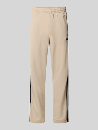 Produktfoto, Trainingshose met logo model 'FIREBIRD' van adidas Originals, regular fit, elastische band, ritszakken, beige met zwarte details, binnenbeenlengte maat M 79 cm