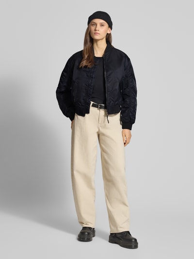 Frauenmodel trägt Bomberjacke mit Stehkragen und Reißverschluss Modell 'SCOUT' von Levi's®, Regular Fit, schwarz, Ganzkörperansicht von vorne.