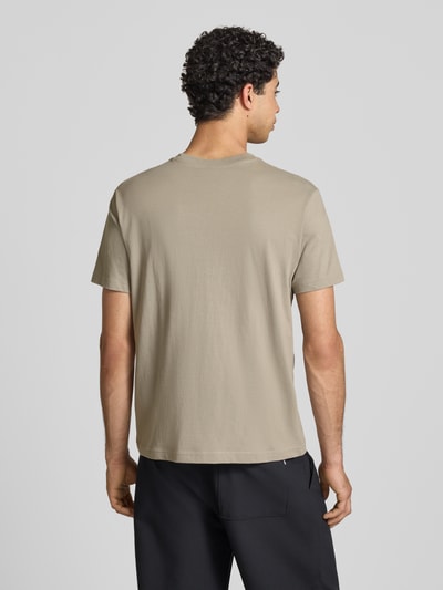 Männermodel trägt T-Shirt mit Label-Stitchings und Rundhalsausschnitt von CHAMPION aus Reine Baumwolle, Regular-Fit, Rückenlänge 66 cm, Rückenansicht.