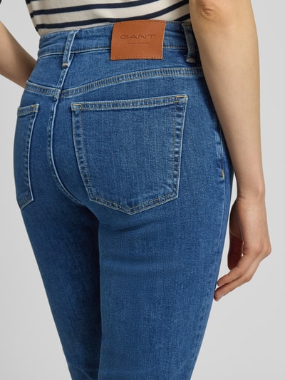 Frauenmodel trägt Slim Fit Bermudas mit Eingrifftaschen von Gant aus Baumwoll-Elasthan-Mix in Blau, Detailaufnahme Rückansicht. Bundweite und Innenbeinlänge in cm bei Größe 27.