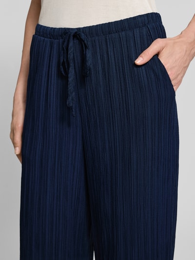 Frauenmodel trägt Hose mit Strukturmuster Modell 'Grsvalse' von FREE/QUENT, dunkelblau, elastischer Bund mit Tunnelzug, Nahaufnahme Oberkörper.